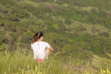Girl Hiking Wilderness overlooking rural valley landscape summer.