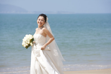 Fototapeta na wymiar Happy bride on the beach