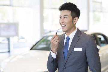 Confident car salesman with headset
