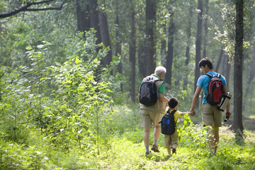 Fototapeta premium Boy hiking with his father and grandfather
