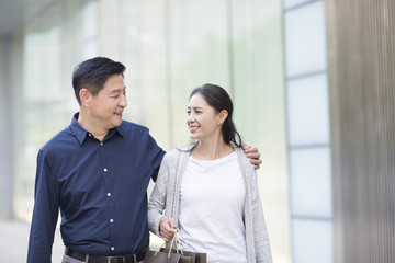 Happy mature couple shopping