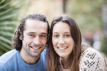 Happy loving couple. Portrait of beautiful smiling young couple standing outdoors