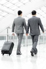 Business partners on the move in airport lobby