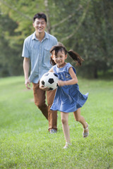 Obraz premium Happy father and daughter playing football