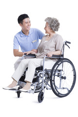 Plakat Male nursing assistant taking care of senior in wheelchair