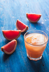 Grapefruit beverage on the wooden background