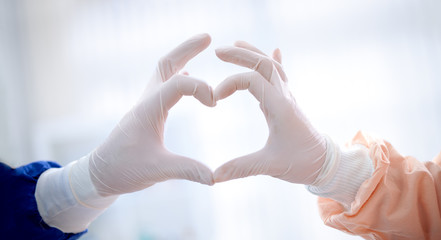 close up of doctors hands  making heart shape