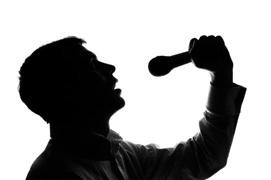 A young man singing into a microphone