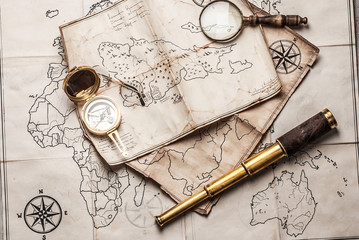 Fototapeta na wymiar An old brass compass on map background