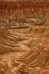 Dry valley red orange sand stone rock formation in hot desert of Tatacoa, Huila