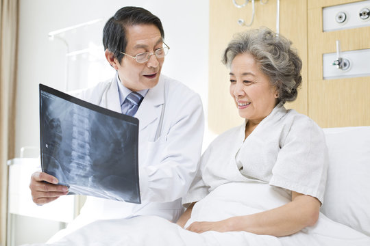 Doctor showing X-ray image to the patient in the hospital