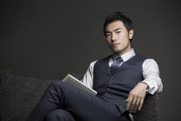 Portrait of businessman relaxing on couch