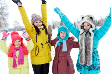 Happy family jumping on a winter afternoon walk