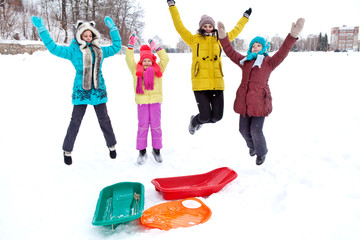 Obraz premium Merry company of children jumping on a winter afternoon walk