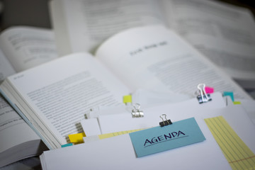 Agenda; Stack of Documents with Large Amount of Reading Material