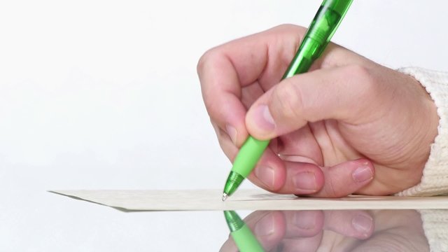 Young Man Writing by Hand with a Pen.

Writer writes his last novel.
Businessman writing a letter with a ballpoint pen.
A young boy writes a letter by hand with a green ball pen.
