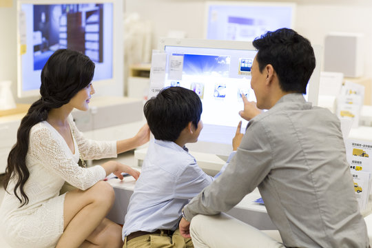 Happy family touching the computer screen