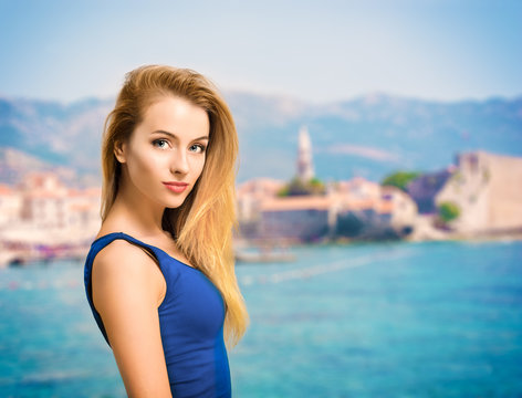 Portrait Of Young Woman In Blue Top At Sea