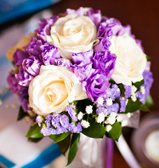 Bride's bouquet with white roses and purple flowers