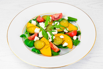 Healthy and Diet Food: Salad, Persimmon, Pickled Cucumber, Tomat