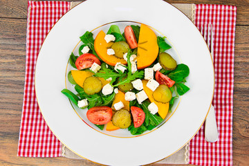 Healthy and Diet Food: Salad, Persimmon, Pickled Cucumber, Tomat