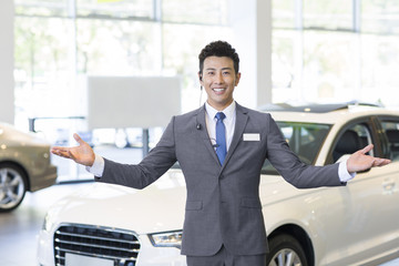 Confident car salesman with headset