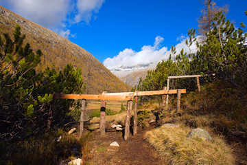 Wooden Fence for Grazing in Mountain / Mountain hiking trail with a wooden fence for grazing. National Park of Adamello Brenta. Trentino Alto Adige, Italy