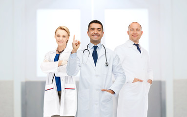 group of doctors at hospital pointing finger up