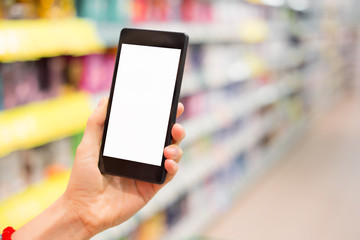 Person holding smartphone in supermarket
