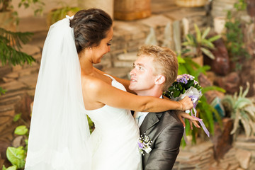 Groom holding bride in dance pose on wedding day