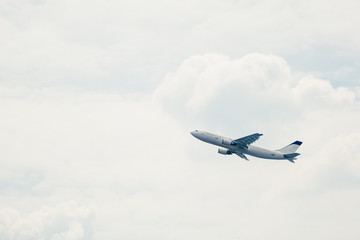 Fototapeta na wymiar departure of an aircraft, white sky background