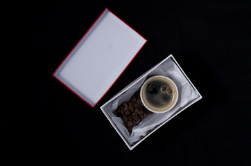 a cup of coffee in a gift box
