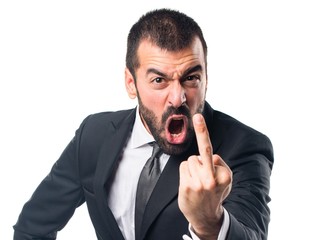 Businessman making horn gesture