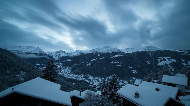 Day to night timelapse of moving clouds over the Val d'Anniviers, a valley of the pennine alps, Valais canton, Switzerland.