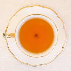 Cup of tea on a wooden background top view