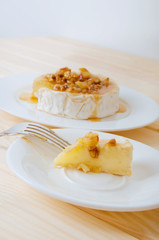 Camembert cheese with honey sauce with nuts and butter
