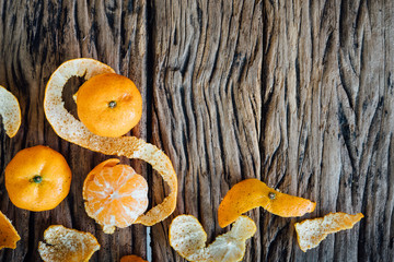 Orange with  peel on wooden background.