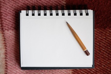 notebook with a pencil