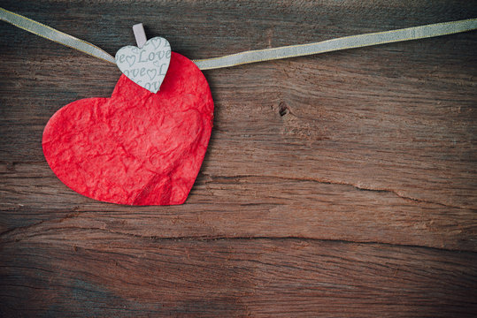 Red heart on wooden background.