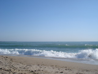 Foamy broken wave at sea shore
