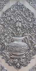 Thai style silver carving art on temple wall.