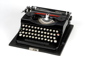 Old typewriter machine isolated on white