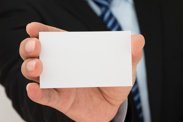 Man hand holding a business card