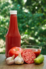 Tomato, garlic, cucumber, hot pepper, bottle of ketchup and juice