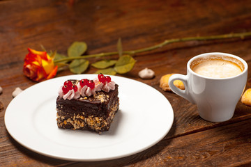Rose, a cup of cappuccino and cake