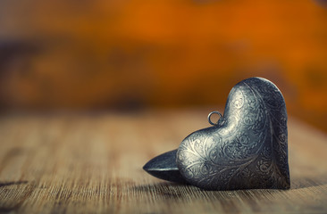 Valentines day. Wedding day. Metal hearts on wooden background - table. Valentines two silver heart with ornaments. Free space for your love text.
