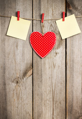 Red heart hanging on the clothesline for Valentine Day