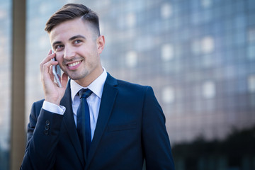 Smiling businessman and phone