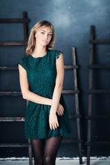 Nice Girl in Fashion Green Dress. Studio Portrait