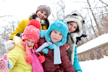 Fototapeta premium The company of cheerful happy children on winter walks
